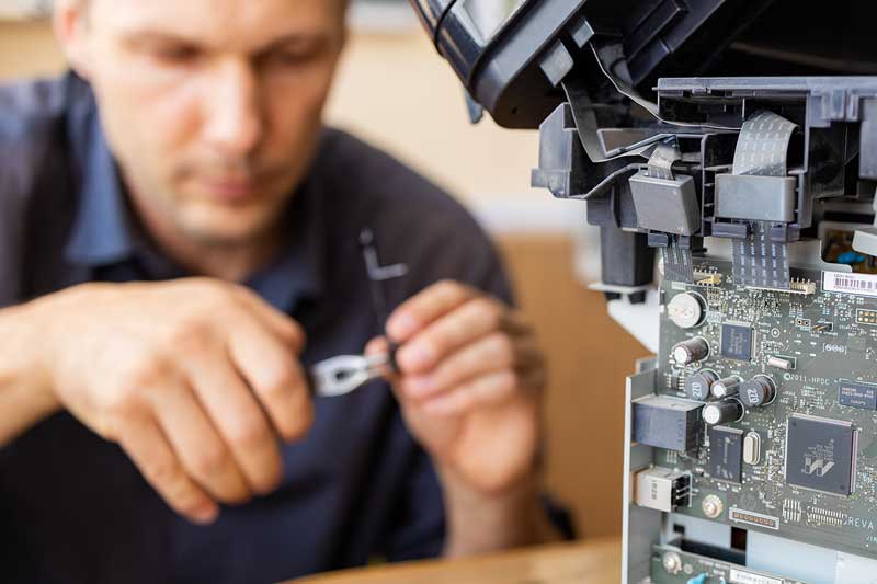 Technician working on a printer